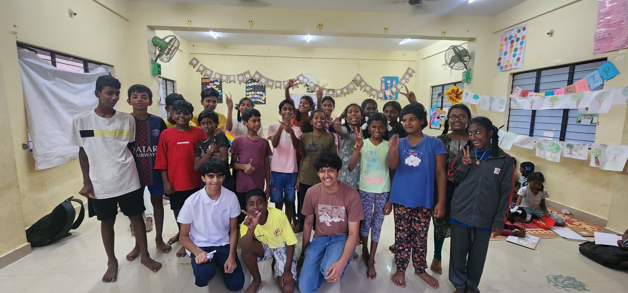 Students and facilitators smiling for a group portrait