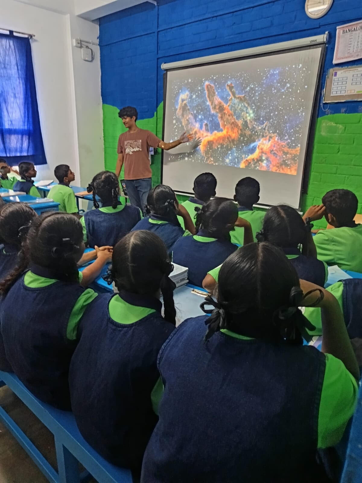 Students watching an astronomy presentation in a classroom