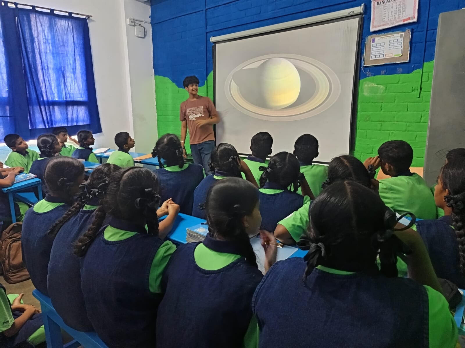 A WIEMO facilitator presenting an illustration of Saturn to students