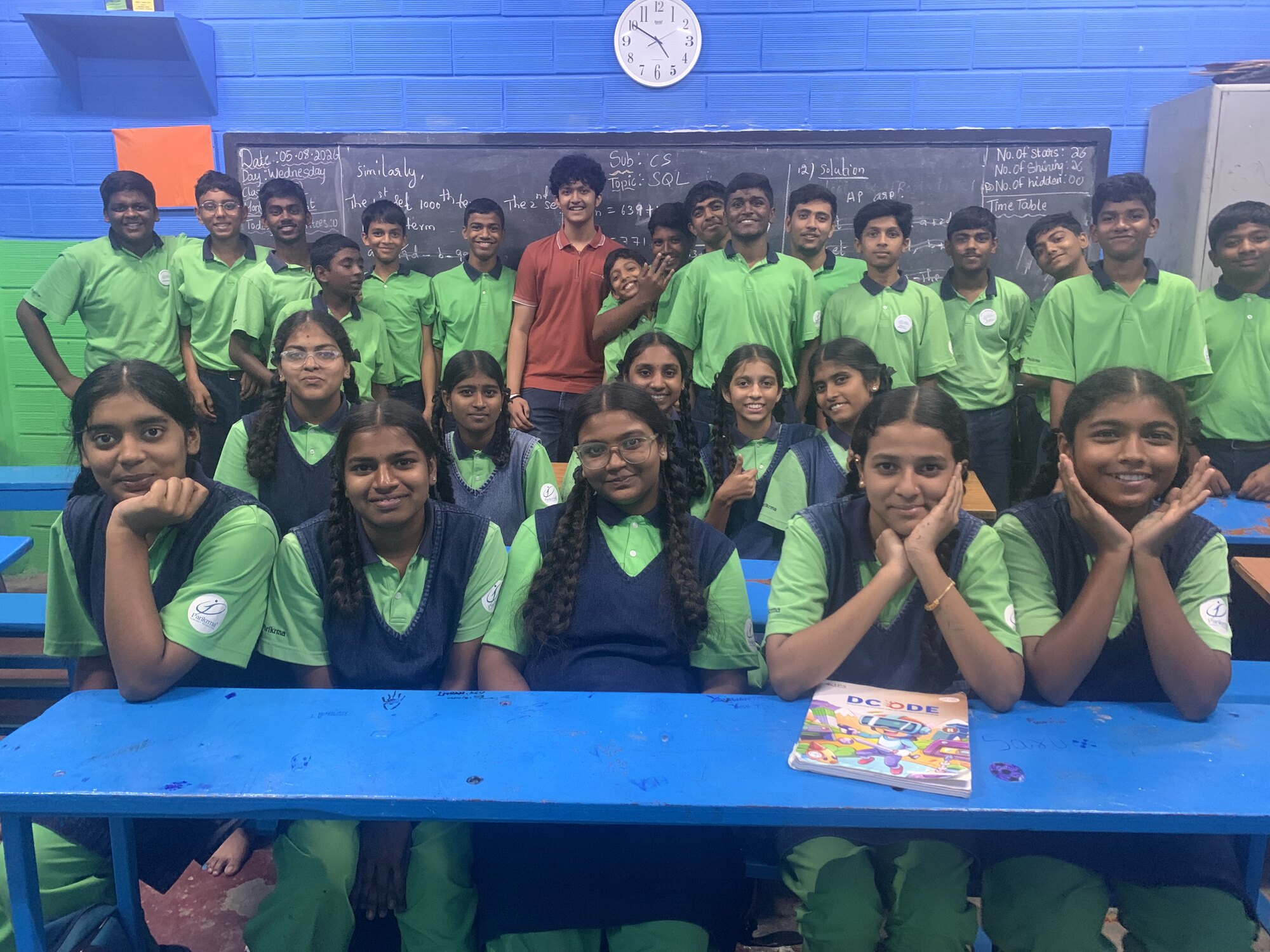 Students and WIEMO facilitators gathered for a classroom portrait